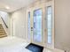 Bright foyer featuring white tile flooring and a front door with sidelights at 7641 Modica St, Clermont, FL 34714