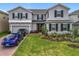 Charming two-story home with a manicured lawn, tasteful landscaping, and a brick driveway at 7641 Modica St, Clermont, FL 34714