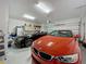 Spacious two car garage featuring overhead lighting and epoxy flooring at 7641 Modica St, Clermont, FL 34714