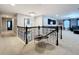 Hallway with black railing, chandelier, and views into the bonus room at 7641 Modica St, Clermont, FL 34714