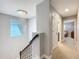 Upstairs landing featuring a modern chandelier, window, and views into bedrooms at 7641 Modica St, Clermont, FL 34714