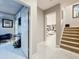 Bright hallway with staircase leading to the second floor and open floor plan at 7641 Modica St, Clermont, FL 34714