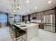 Contemporary kitchen with a large island, stainless steel appliances, and stylish bar stool seating at 7641 Modica St, Clermont, FL 34714