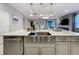 Bright, open kitchen featuring stainless steel appliances, a large island, and modern pendant lighting at 7641 Modica St, Clermont, FL 34714