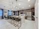 Expansive kitchen with island seating, stainless appliances, and view to dining area at 7641 Modica St, Clermont, FL 34714