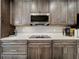 Gourmet kitchen featuring dark cabinetry and stainless steel appliances at 7641 Modica St, Clermont, FL 34714