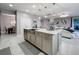 Island with a stainless steel sink, light-colored cabinets, and pendant lighting at 7641 Modica St, Clermont, FL 34714