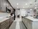 Spacious kitchen featuring dark wood cabinets and a large island with a sink at 7641 Modica St, Clermont, FL 34714