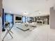 Spacious living room with white sofas, modern lighting, and an open layout to the kitchen at 7641 Modica St, Clermont, FL 34714
