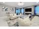 Cozy living room featuring stylish furniture, a modern lighting fixture, and large windows at 7641 Modica St, Clermont, FL 34714