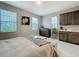 Serene main bedroom featuring a kitchenette and abundant natural light at 7641 Modica St, Clermont, FL 34714