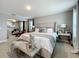 Large primary bedroom with a sitting bench and lots of natural light at 7641 Modica St, Clermont, FL 34714