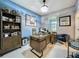 Stylish home office with wood desk, shelving, tile floors, and tasteful decor at 7641 Modica St, Clermont, FL 34714