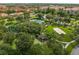 Community volleyball court and putting green, surrounded by lush tropical landscaping and mature trees at 7670 Otterspool St, Kissimmee, FL 34747