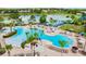 An aerial view of the community pool and waterpark with abundant seating and lake view at 7670 Otterspool St, Kissimmee, FL 34747