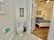 Bathroom adjacent to a bedroom, featuring a toilet, sink, and doorway to the bedroom at 7670 Otterspool St, Kissimmee, FL 34747