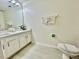 Clean bathroom featuring a white vanity, toilet, and modern fixtures at 7670 Otterspool St, Kissimmee, FL 34747