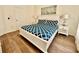 Well-lit bedroom with a bed, matching nightstands, and modern decor at 7670 Otterspool St, Kissimmee, FL 34747