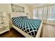 Bright bedroom featuring a bed, nightstands, and a window with sheer curtains at 7670 Otterspool St, Kissimmee, FL 34747