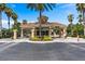 Secure Windsor West community gate with lush landscaping and a clear blue sky at 7670 Otterspool St, Kissimmee, FL 34747