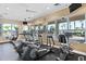 Fully equipped fitness center featuring modern treadmills, ellipticals, and stationary bikes overlooking a pool at 7670 Otterspool St, Kissimmee, FL 34747
