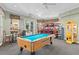 The community game room features a pool table, arcade games, and plenty of space to enjoy time with your neighbors at 7670 Otterspool St, Kissimmee, FL 34747