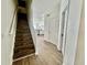 Hallway and stairs with wood floors leading to the living spaces at 7670 Otterspool St, Kissimmee, FL 34747