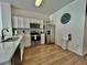 Bright kitchen with stainless steel appliances, white cabinetry, and wood-look flooring at 7670 Otterspool St, Kissimmee, FL 34747