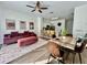 Inviting open-concept living and dining area featuring modern decor, stylish furniture, and natural light at 7670 Otterspool St, Kissimmee, FL 34747