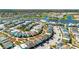 Aerial view shows colorful homes in planned community with parking, sidewalks, and mature trees at 8012 Lost Shaker Ln, Kissimmee, FL 34747
