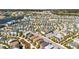 A high angle aerial view of colorful homes in a planned community with sidewalks and mature trees at 8012 Lost Shaker Ln, Kissimmee, FL 34747