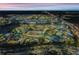 An aerial view showcases a vibrant water park lit up at night, surrounded by city lights and clear roads at 8012 Lost Shaker Ln, Kissimmee, FL 34747