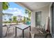 Paver patio with table and chairs offering a view of the community landscaping and colorful homes at 8012 Lost Shaker Ln, Kissimmee, FL 34747