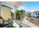 Enjoy the beautiful view from this covered balcony with comfortable seating and a white metal railing at 8012 Lost Shaker Ln, Kissimmee, FL 34747