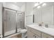 Bright bathroom featuring a glass framed shower, white cabinets, and modern fixtures at 8012 Lost Shaker Ln, Kissimmee, FL 34747