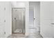 Modern bathroom features a walk-in shower with glass door, a toilet, and a window for natural light at 8012 Lost Shaker Ln, Kissimmee, FL 34747