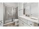Bright bathroom features a framed glass shower, white cabinets, and modern fixtures at 8012 Lost Shaker Ln, Kissimmee, FL 34747