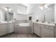 Elegant bathroom showcasing a soaking tub, dual sinks, and ample counter space at 8012 Lost Shaker Ln, Kissimmee, FL 34747