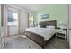 Neutral bedroom with wood-look tile flooring, bright natural light and a wood bed frame at 8012 Lost Shaker Ln, Kissimmee, FL 34747