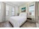This bedroom features bright natural light, wood-look flooring, and neutral wall color at 8012 Lost Shaker Ln, Kissimmee, FL 34747