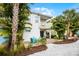 Gorgeous two-story home boasting a patio, balcony, beautiful landscaping, and outdoor seating at 8012 Lost Shaker Ln, Kissimmee, FL 34747