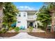 Beautiful two-story home with a patio, balcony, lush landscaping, and outdoor seating at 8012 Lost Shaker Ln, Kissimmee, FL 34747