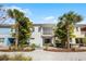 Rear view of home featuring a patio with Adirondack chairs, a dining area, and lush tropical landscaping at 8012 Lost Shaker Ln, Kissimmee, FL 34747
