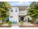Charming back exterior view with a patio, outdoor seating, a balcony, and attractive landscaping at 8012 Lost Shaker Ln, Kissimmee, FL 34747