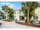 Charming two-story home with patio, balcony, lush landscaping, and comfortable outdoor seating at 8012 Lost Shaker Ln, Kissimmee, FL 34747
