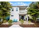 Picturesque two-story home featuring a patio, balcony, lush landscaping, and comfortable seating at 8012 Lost Shaker Ln, Kissimmee, FL 34747