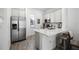 Well-equipped kitchen with stainless steel appliances, white cabinets, and a center island with seating at 8012 Lost Shaker Ln, Kissimmee, FL 34747