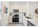 Bright, modern kitchen featuring stainless steel appliances, white cabinets, and a stylish countertop at 8012 Lost Shaker Ln, Kissimmee, FL 34747