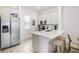 Modern kitchen with stainless steel appliances, white cabinets, and an island with breakfast bar seating at 8012 Lost Shaker Ln, Kissimmee, FL 34747