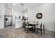 Well-lit kitchen features stainless steel appliances and a breakfast bar adjacent to a dining area at 8012 Lost Shaker Ln, Kissimmee, FL 34747